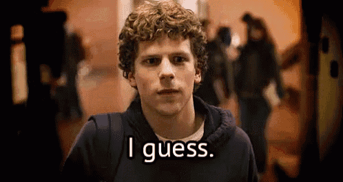 a young man with curly hair is standing in a hallway and says `` i guess '' .