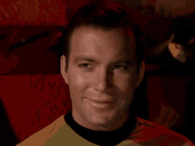 a close up of a man 's face with a red background