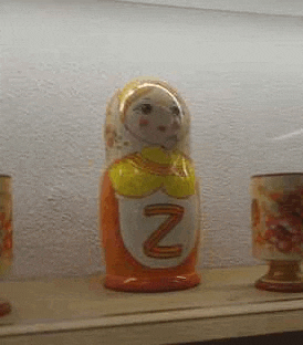 a russian nesting doll with the letter z on it is sitting on a shelf .