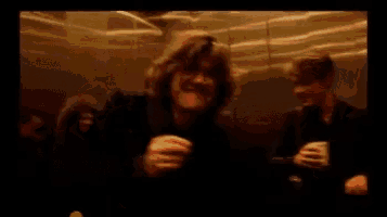 a blurry picture of a man in an elevator holding a cup