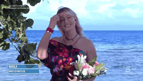 a woman holding a bouquet of flowers with the name manila written on the bottom