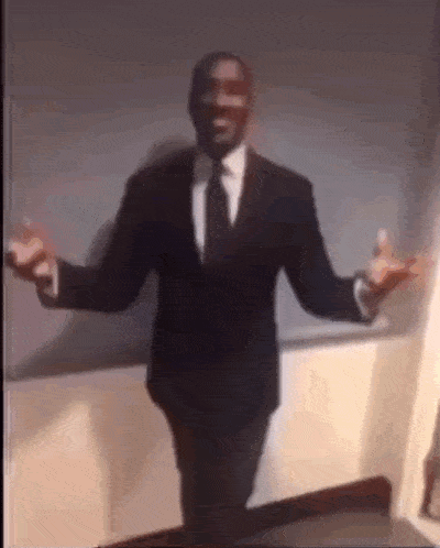 a man in a suit and tie is dancing in a room .
