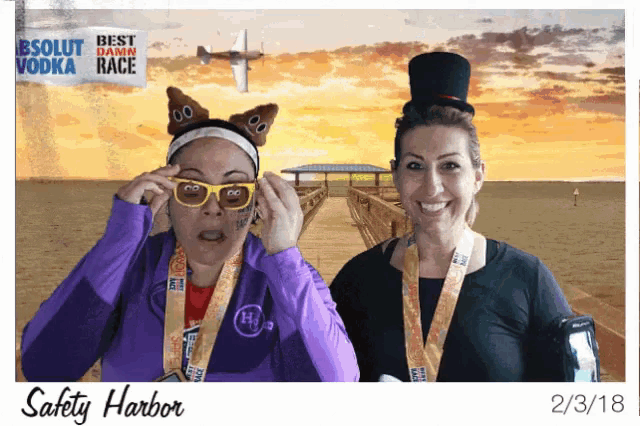 two women are posing for a photo in front of a sign that says " safety harbor "