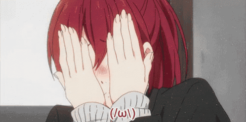 a girl with red hair is covering her face with her hands
