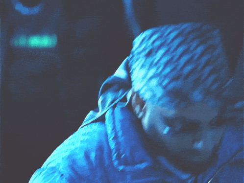 a man in a blue jacket has the word the on the bottom