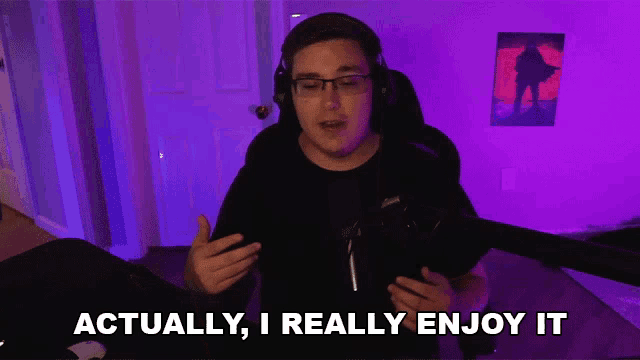 a man wearing headphones and glasses says actually i really enjoy it