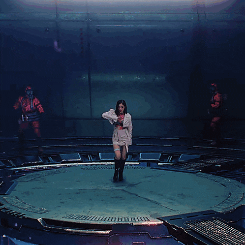 a woman is standing in a circle with her arms outstretched in front of a man in a gas mask