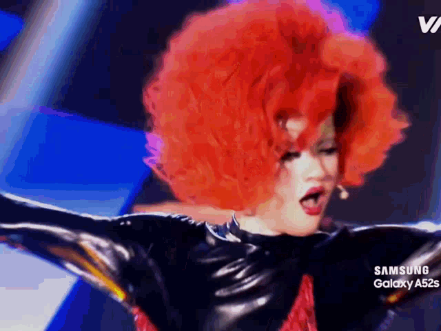 a woman with red hair and a samsung galaxy a52s on the bottom