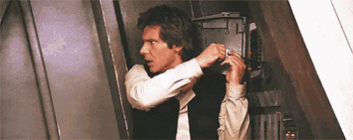 han solo from star wars is standing in a doorway adjusting his hair .