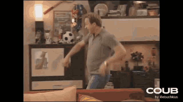 a man dancing in a living room with the word coub on the bottom right