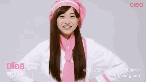 a woman with long hair is wearing a pink hat and tie