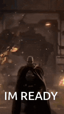 a man in a black suit is standing in front of a fire with the words i 'm ready below him
