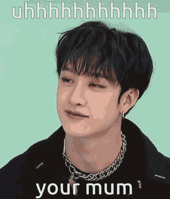 a young man wearing a necklace and earrings is making a funny face and says your mum