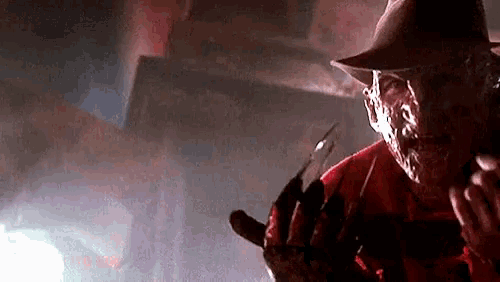 a nightmare on elm street character is holding a knife in his hand .