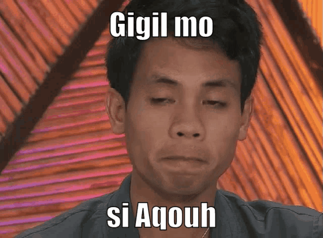 a man is making a funny face with the words gigil mo si aqouh written on his face