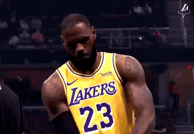 a man wearing a lakers jersey with the number 23 on it