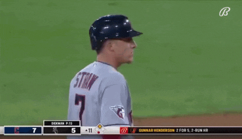 a baseball player in a gray uniform with the letter g on his chest