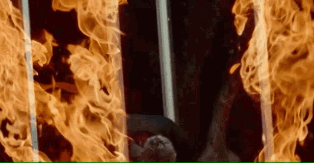 a person is in a room with flames coming out of the walls