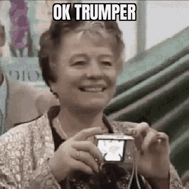 an elderly woman is taking a picture of herself with a camera .