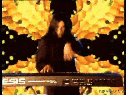 a man is playing a keyboard that says esis