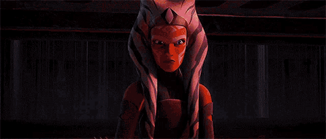 ahsoka tano from star wars is holding a lightsaber in her hands .