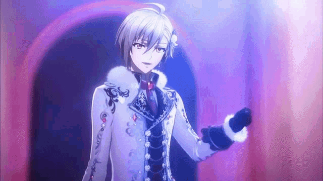 a boy in a white coat is standing in front of a microphone in a dark room .