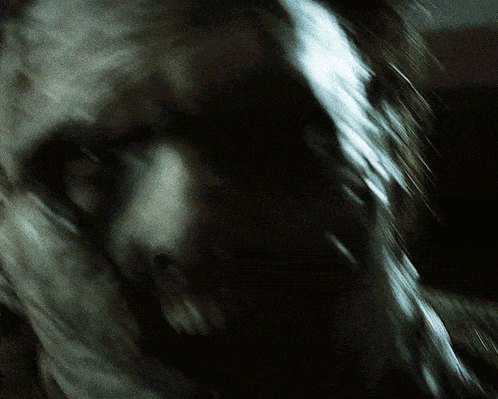 a close up of a person 's face with a blurred image