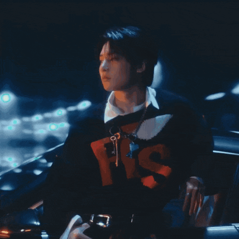 a man wearing a black sweater with the word his on it