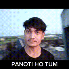 a young man in a black shirt is standing in front of a sign that says panoti ho tum .