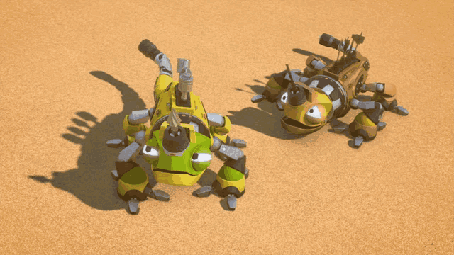 two cartoon robots are laying on the sand