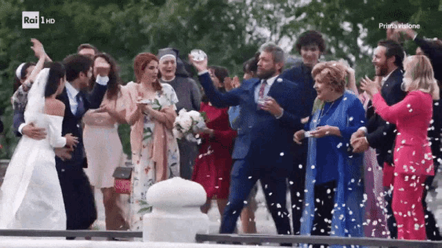 a bride and groom are surrounded by their wedding guests and confetti is being thrown in the air