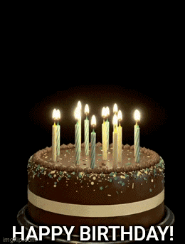 a birthday cake with candles and a balloon that says happy birthday on it
