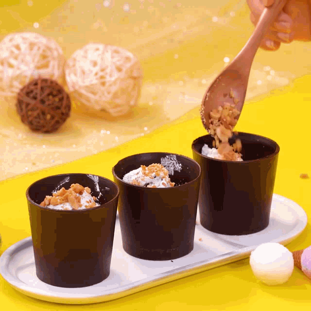 a person pouring a spoonful of food into a cup