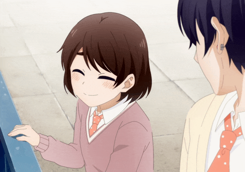 a girl in a pink sweater and tie is smiling next to a boy