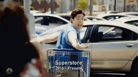 a man pushing a shopping cart in front of a car with the year 2015 on it