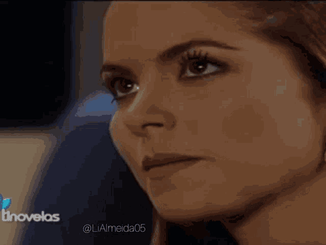 a close up of a woman 's face with the words tinovelas in the corner