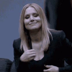 a woman wearing a black jacket and a black shirt is smiling .