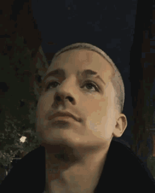 a close up of a man 's face with a black background