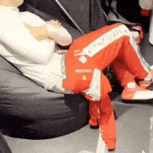 a man is sitting on a bean bag chair with his legs crossed and his pants saying p2 on them