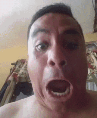 a man without a shirt is making a funny face with his mouth wide open
