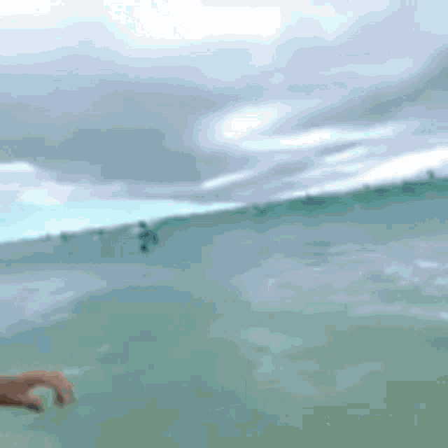 a person is riding a wave in the ocean .