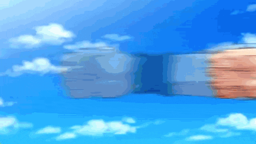 a blurry picture of a person 's fist against a blue sky with clouds