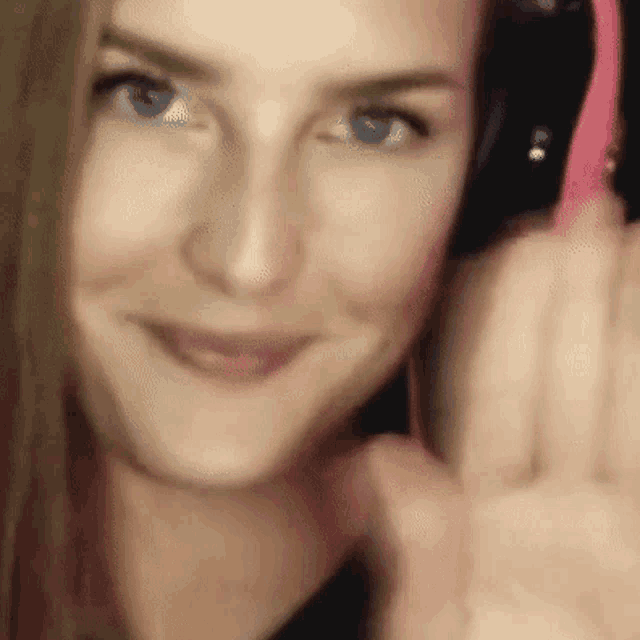 a close up of a woman 's face while wearing headphones
