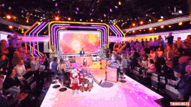 a group of people sitting in front of a stage that says thinkjules on the bottom