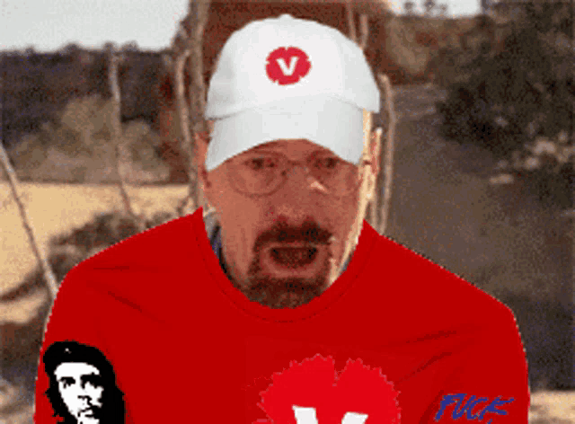 a man wearing a red shirt and a white hat with a red v on it