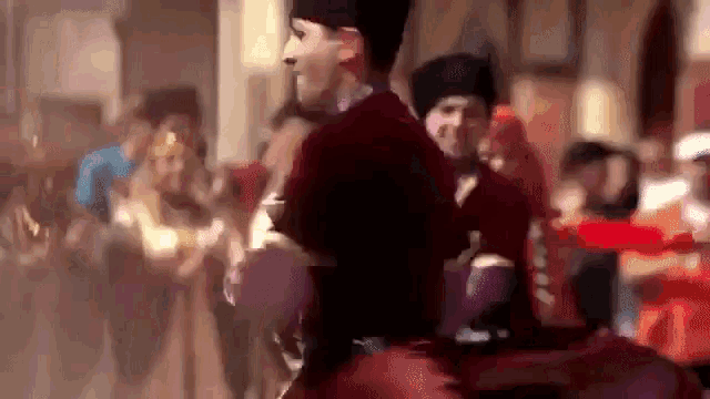 a blurry picture of a group of people dancing in a crowd .