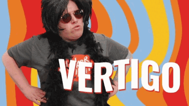 a man wearing a wig and sunglasses is standing in front of a colorful background with the word vertigo on it