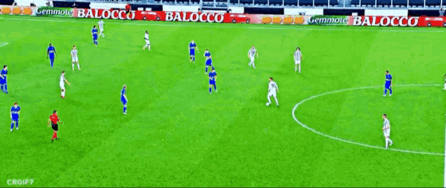 a soccer game is being played on a field with a banner that says guardian on it
