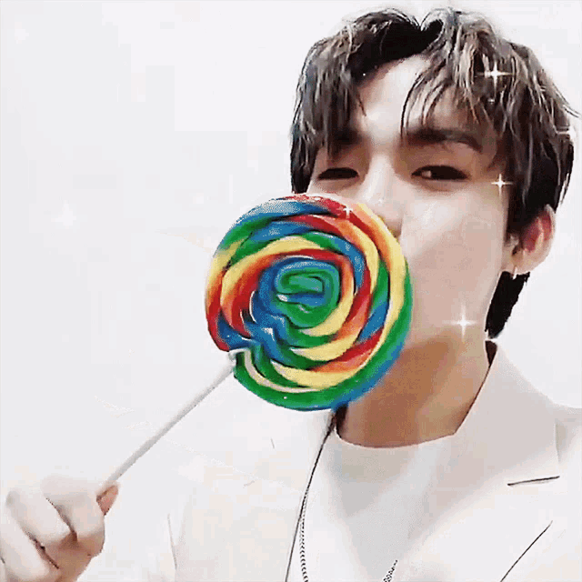a man with a lollipop in his mouth with the letter s visible