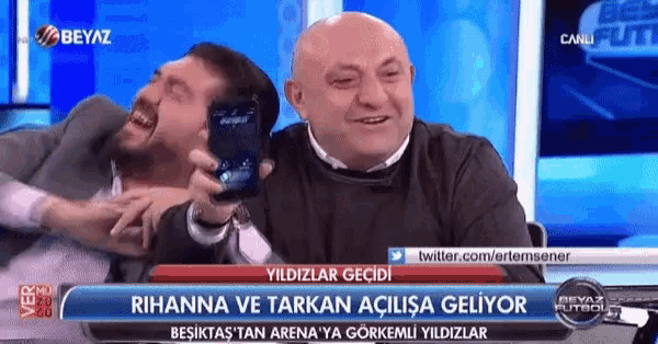 two men are laughing in front of a blue screen that says beyaz